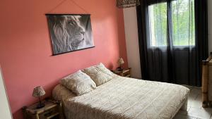 a bedroom with a bed and a picture on the wall at Maison Thierry in Pierre Penot
