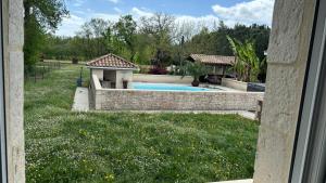 a backyard with a swimming pool and a gazebo at Maison Thierry in Pierre Penot