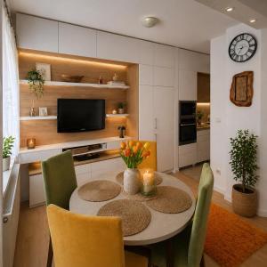 a kitchen with a table and chairs and a television at Garden lux 1 in Belgrade +6 photos