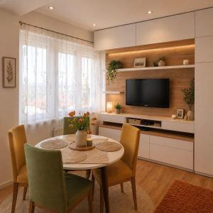 a dining room with a table and a tv at Garden lux 1 in Belgrade
