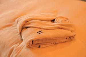 a towel sitting on top of a bed at Domaine Wabi sabi lodge - 2 lodges d'exception - forêt in Turenne