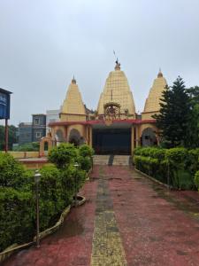 a temple with two domes on top of it at Paras home in Deoghar