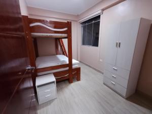 a bedroom with two bunk beds and a closet at Casa Sol in Tingo María