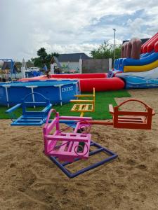 a playground with colorful play equipment in the sand at Angel homestay hotel in Mikumi
