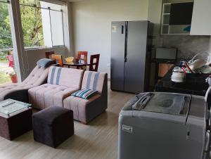 a living room with a couch and a refrigerator at Casa Sol in Tingo María +20 photos