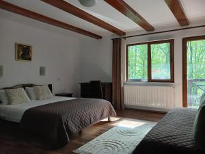 a bedroom with a bed and a large window at Casa Sf Nicolae in Sinaia