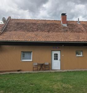 a house with a table and chairs in front of it at Haus Alexander in Hart bei Graz