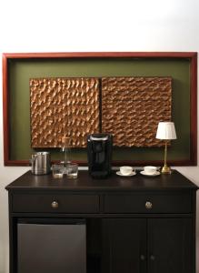 a table with a coffee maker and a lamp on it at Casa Lucienne in San Juan