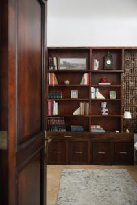 a room with a book shelf filled with books at Casa Lucienne in San Juan