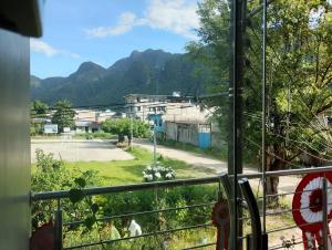 a window with a view of a street and mountains at Casa Sol in Tingo María