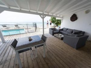 a living room with a couch and a table at Coco Beach Resort Marie-Galante in Grand-Bourg