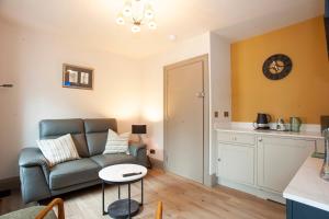 a living room with a couch and a table at Causeway Squarings in Bushmills