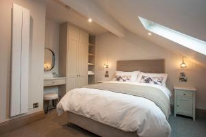 a bedroom with a bed and a desk and a window at Causeway Squarings in Bushmills +16 photos