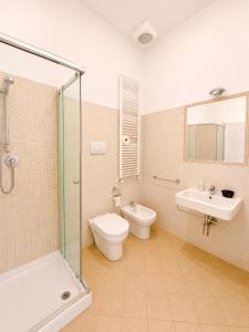 a bathroom with a toilet and a sink and a shower at Locanda Al Sole in Vo Euganeo