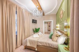 a bedroom with a bed and a chandelier at MInerva Pantheon Suites in Rome