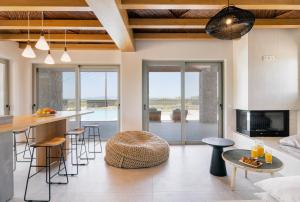 a kitchen and living room with a table and chairs at The Retreat Villa in Lefkada