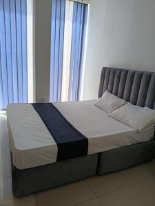 a bed in a room with a large window at Dil Apartments - Mount Lavinia in Mount Lavinia