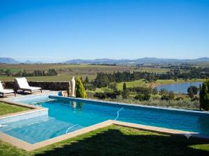 a swimming pool in a yard with a view of a lake at Casa Mori House in Stellenbosch +36 photos