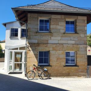 a bike parked in front of a building at Unterkunft in Kreuz 49 in Bayreuth +11 photos