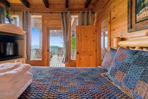 a bedroom with a bed and a view of a deck at Mountain Magic #73 by Venture Smoky Mountains in Sevierville