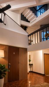 an empty lobby with a staircase in a building at Cocohouse Sukhumvit 1 in Makkasan