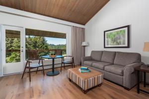 a living room with a couch and a table at Salishan Coastal Lodge by SCP Hotels in Lincoln City