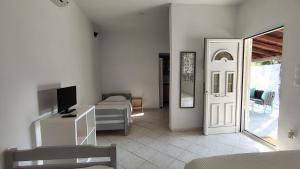 a room with a desk with a computer and a door at Villa Elena in Ormos Panagias