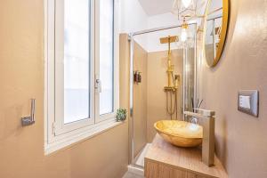 a bathroom with a large wooden bowl sink on a counter at MInerva Pantheon Suites in Rome +23 photos