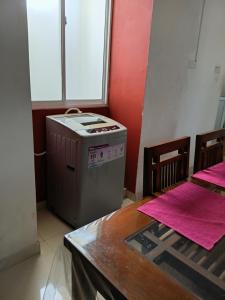 a kitchen with a stove and a table and a window at Dil Apartments 2 in Mount Lavinia