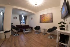 a living room with a couch and chairs at Prague Gate Apartments in Prague