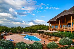 a resort with a swimming pool and a building at Maasai ecoLodge in Karatu