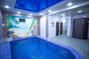 a swimming pool in a bathroom with a painting on the wall at Suleyman House Premium in Bukhara +24 photos