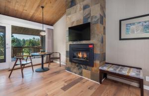 a living room with a fireplace and a tv at Salishan Coastal Lodge by SCP Hotels in Lincoln City