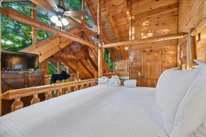 a bedroom with a large bed in a cabin at Once Upon a Time by Venture Smoky Mountains in Sevierville