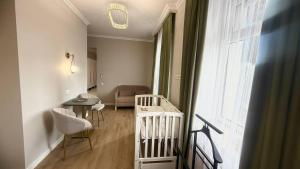 a room with a crib and a table and a chair at Malishka Eco Villas in Malishka +84 photos