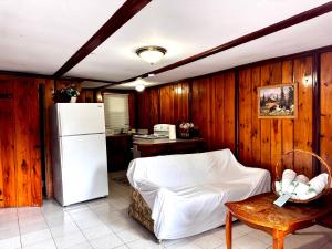 a kitchen with a white refrigerator and a table at Rock Castle Resort in Lake George