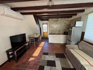 a living room with a couch and a kitchen at Casa Miramar in Quellón +7 photos