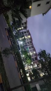 a tall apartment building with trees in front of it at Kerry Luxury Stays in Athi River
