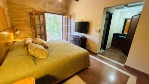 a bedroom with a bed with two pillows on it at Fina residencia con chimenea en Lambaré in Asunción