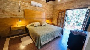 a bedroom with a bed and a large window at Fina residencia con chimenea en Lambaré in Asunción +60 photos