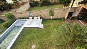 an aerial view of a backyard with a pool and two chairs at Fina residencia con chimenea en Lambaré in Asunción