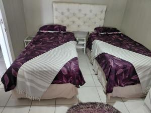 two beds sitting next to each other in a room at Ocean River no 1 in Gqeberha