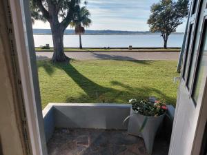 an open door with a view of the water at Ocean River no 1 in Gqeberha