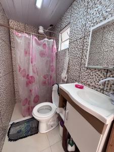 a bathroom with a toilet and a sink at BECO 6 house in Petrópolis