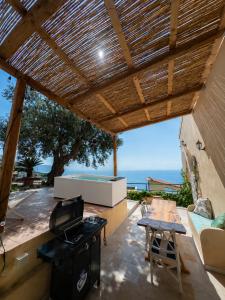 an outdoor patio with a grill and a table at Torre del Califfo Amalfi Relais in Amalfi