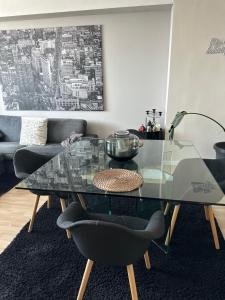 a dining room with a glass table and chairs at Camera Deluxe in favoloso attico vista mare in Rimini +16 photos