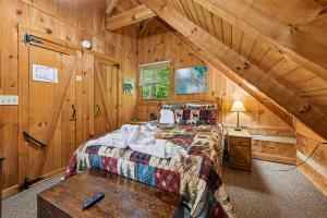 a bedroom with a bed in a wooden cabin at Sequoyah by Venture Smoky Mountains in Cartertown