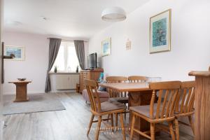 a dining room with a table and chairs at Wiesenweg W10 in Laboe