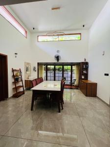 a dining room with a table and chairs at South Elegance in Tellicherry