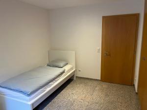 a small bedroom with a bed and a door at Château Schnidrig in Stalden